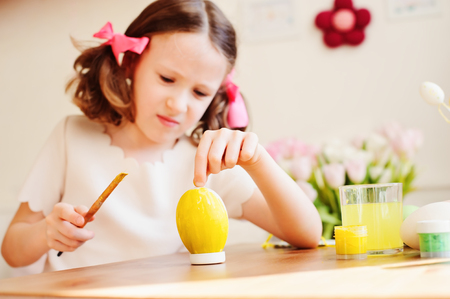 easter craft with kids - painting eggs at home. Seasonal spring decorationsの写真素材