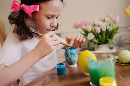 easter craft with kids - painting eggs at home. Seasonal spring decorationsの写真素材