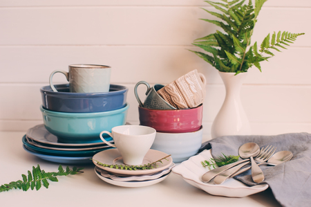 natural crockery tableware on wooden background. Ceramic dished and cups in neutral tones, scandinavian style.の写真素材