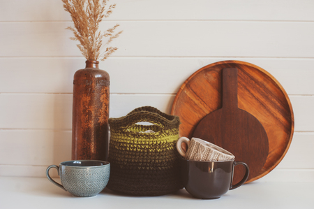 natural rustic handmade kitchenware on wooden background. Ceramic dished and cups in neutral tones, scandinavian style.の写真素材