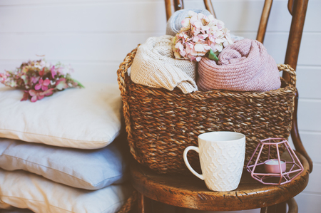 cozy still life interior details. Organizing clothes in wicker backets, seasonal wardrobe cleaning, ideas for winter season.の写真素材