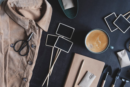 spring garden preparations. sowing seeds. Flat lay on black background with tags, tools, notes and coffee.の写真素材