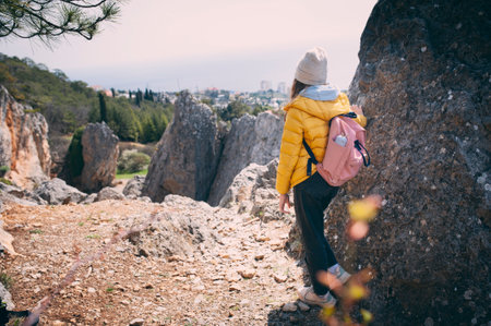 teen girl hiking in mountains. Travel activity. Happy vacations, exploring nature and healthy life conceptの写真素材