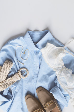 spring woman's fashion concept. Flat lay trendy outfit with blue shirt, feminine underwear, shoes and belt.の写真素材