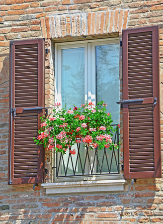 wall of brick on the window flowersの写真素材