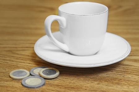 cup of coffee on the table coinの写真素材