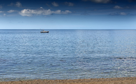 boat floating on the sea promenade summer weatherの写真素材