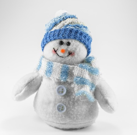 toy snowman on it blue hat and scarfの写真素材