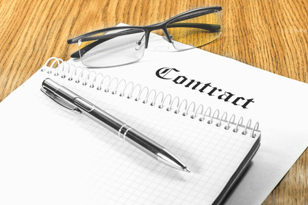 contract business papers pen glasses business caseの写真素材