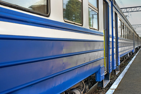 blue train cars are at the station, linear perspectiveの写真素材