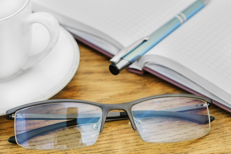 glasses pen on the table and padsの写真素材