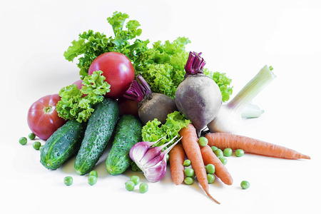 vegetables isolated on a white background tomatoes, garlic, peas, lettuce, beets. carrotsの写真素材