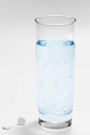 glass of soda water and pillsの写真素材