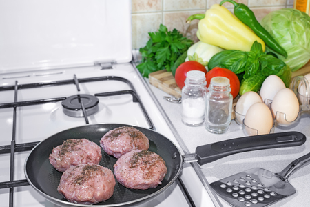 meatballs in a pan on a gas stove covered with fragrant pepper in the background Vegetables eggs and spicesの写真素材