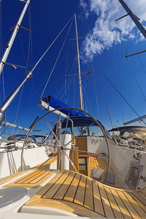 sailboat with lowered sail on a sunny day, wheel, mast, yachting, boat tripの写真素材
