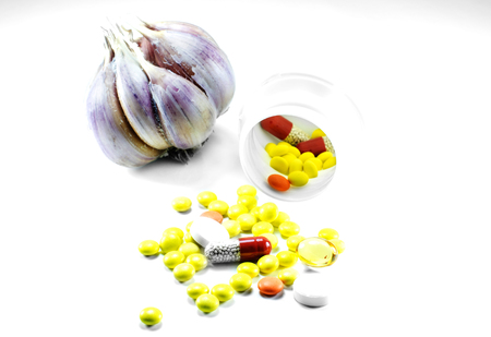 rash pill bottles with garlic on a white backgroundの写真素材