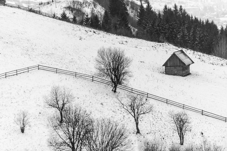 Lonely wooden house in winter somewhere in the mountains monochromeの写真素材