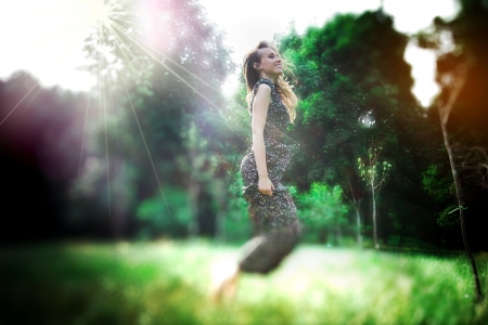 Dreamy photo of yong pretty woman jumps in a fairy forest  Defocusedの写真素材