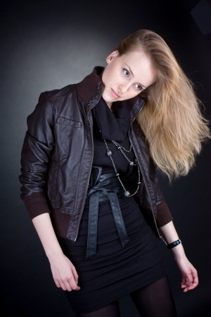 Sad beautiful blonde woman stands  Dark backgroundの写真素材