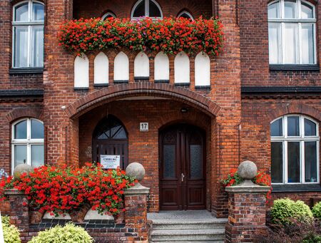 Facade from red bricks with flowers in Gdansk, Polandの写真素材