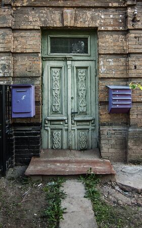 Old green wooden door in Kyiv, Ukraine.の写真素材