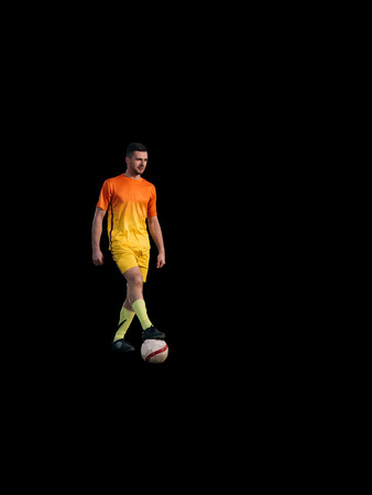 Young soccer player standing on black backgroundの写真素材