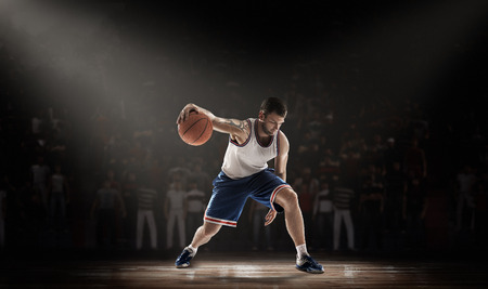 basketball player on stadium in durkness with light rayの写真素材