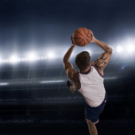 basketball player in action on the basketball court at night under spotlights