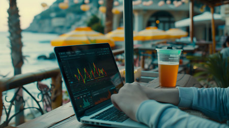 working, trading and investing with labtop or notebook screen stock chart at the beach, Work anywhere without restriction conceptの素材
