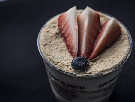 Top view of a strawberry cheesecake on dark backgroundの写真素材