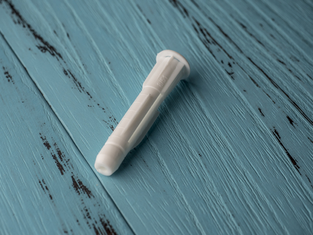 Plastic expansion on wooden blue backgroundの写真素材