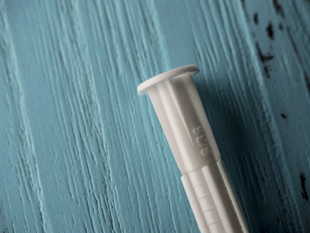Plastic expansion on wooden blue backgroundの写真素材