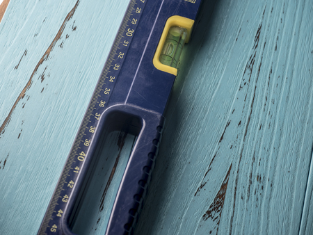 Level ruler close up view on blue wooden backgroundの写真素材