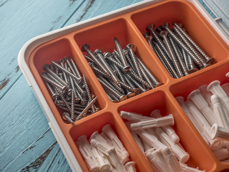 screw in tool box on blue wooden backgroundの写真素材