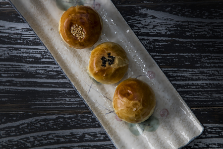 Egg-yolk puff on a plate on dark backgroundの写真素材