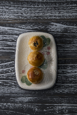 Egg-yolk puff on a plate on a black wooden backgroundの写真素材
