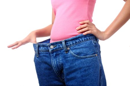 lady stretching her pants to show loss of weightの写真素材