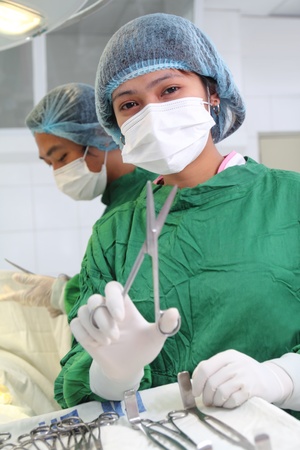 asian female nurse assistant with instrument.focus is on the faceの写真素材