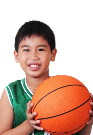 cute asian boy playing basketball in white backgroundの写真素材