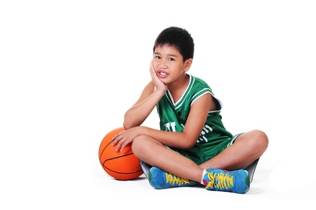 cute boy sitting and relaxing on the floor.white background.の写真素材