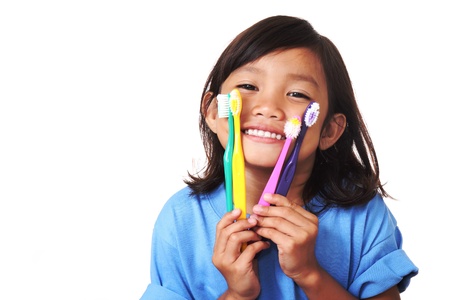 Young girl showing toothbrush and her white teethの写真素材