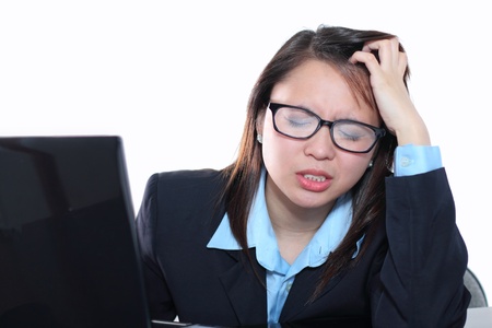 Young businesswoman feeling tired and stressedの写真素材