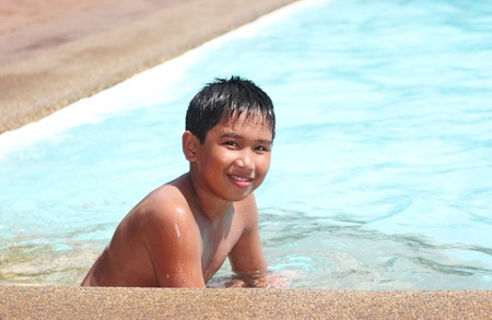 Smiling asian boy in the swimming pool.