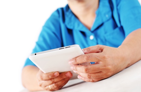 Close up ofa businesswoman's hands holding a tablet computer.Isolated in white background.の写真素材