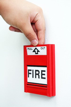Close up image of a hand pulling a fire alarm.の写真素材