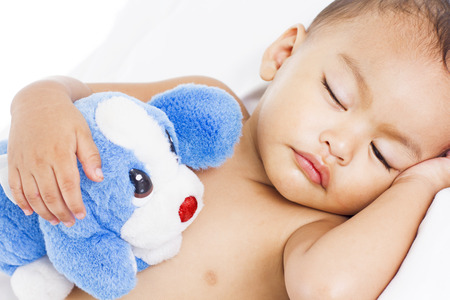 Sleeping little cute boy hugging a toy.の写真素材