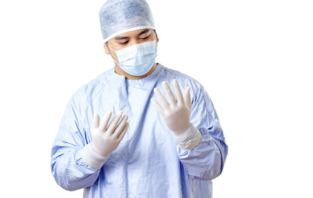  Portrait of a prayerful surgeon looking at his hands. Concept. Isolated in white background.の写真素材