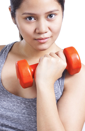 Close up portrait of a young lady with a dumb bell.の写真素材