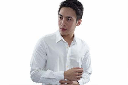 Portrait of a successful male businessman isolated in white background. Asian model looking to his right.の写真素材