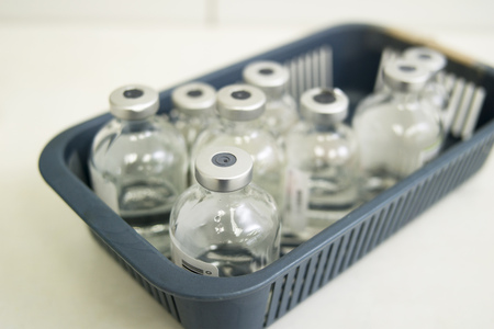 Empty vials of medicine in a medical tray.の写真素材